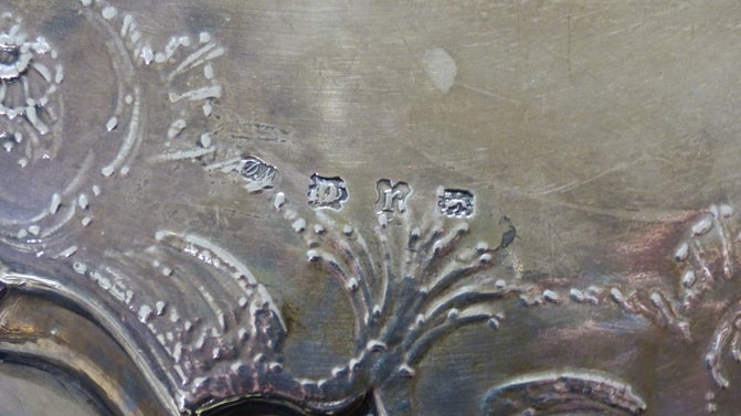 A closeup of the Mills Salver at Baddesley Clinton, Warwickshire, showing the hallmark